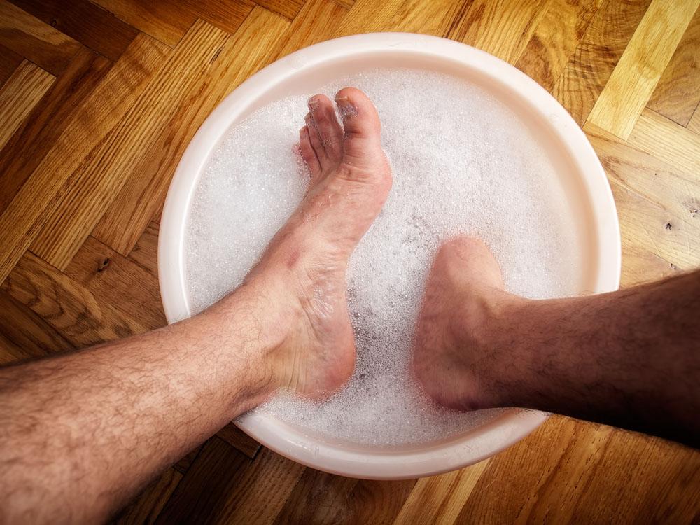 man soaking his feet