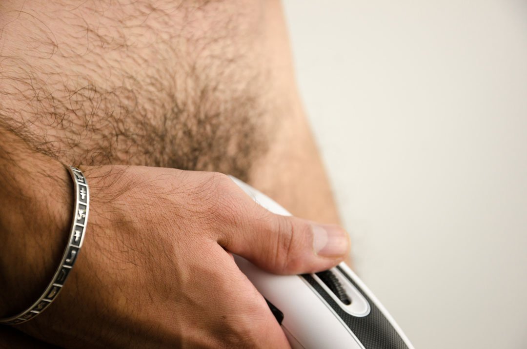 man shaving pubic hair